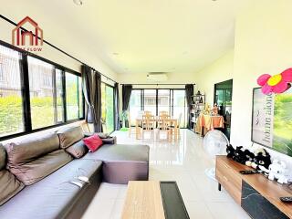 Spacious living room with large windows and modern decor