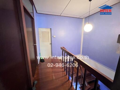 Staircase area with wooden steps and blue walls