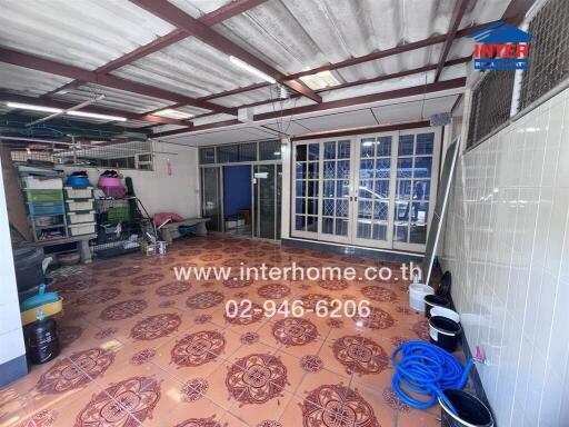 Covered outdoor area with storage and tiled floor