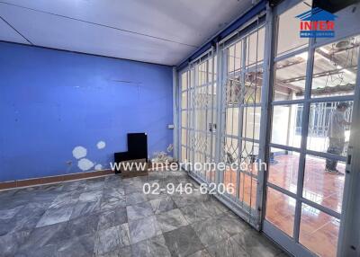 Main living area with large windows and tiled floor