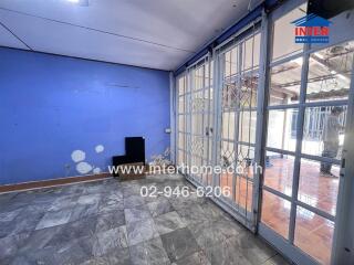 Main living area with large windows and tiled floor