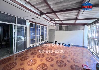 covered balcony with tiled floor and metal railing