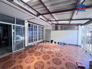 covered balcony with tiled floor and metal railing