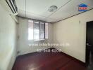 Empty bedroom with hardwood floors and a window