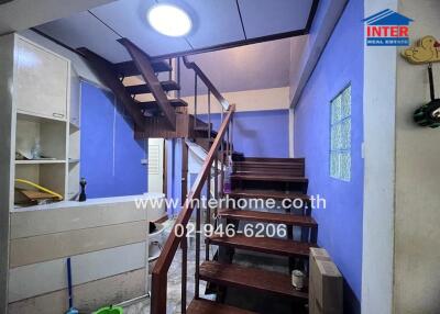 Staircase area with blue-painted walls