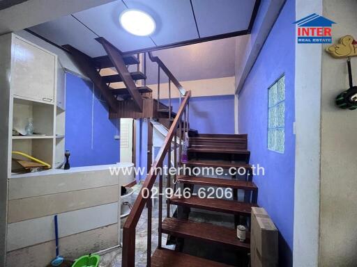 Staircase area with blue-painted walls