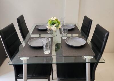 Modern dining table setup with four chairs