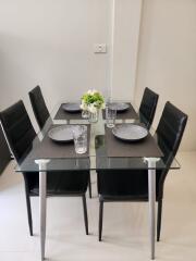 Modern dining table setup with four chairs