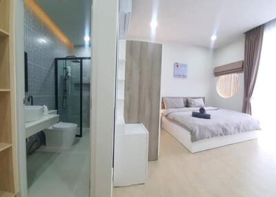 View of a modern bedroom adjacent to a bathroom