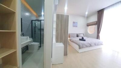 View of a modern bedroom adjacent to a bathroom