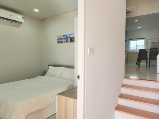 Modern bedroom leading into a dining area