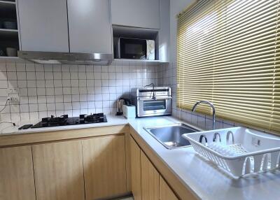 Modern kitchen with wooden cabinets and appliances