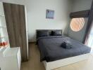 Modern bedroom with bed, wardrobe, and natural light