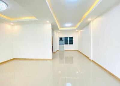 Spacious, well-lit living room with modern ceiling lights and tiled floor