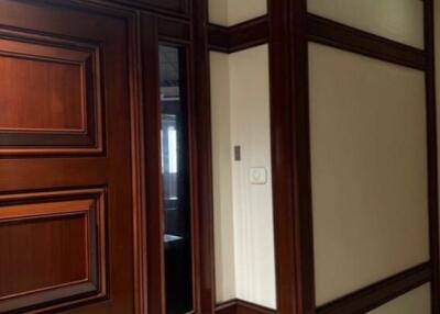 hallway with wood paneling and door