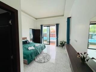 Spacious bedroom with modern decor and balcony access