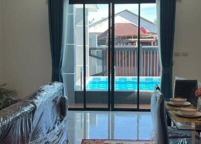 Living room with patio doors leading to a pool