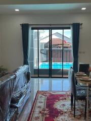 Living room with patio doors leading to a pool