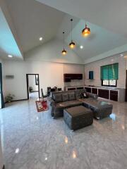 Modern living room with vaulted ceiling and kitchen area