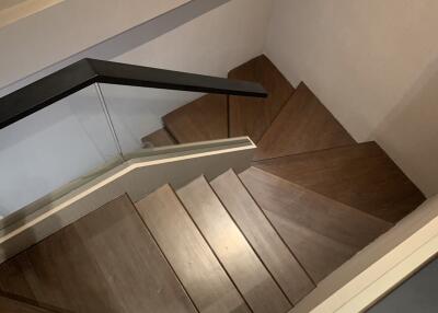 Modern wooden staircase with glass railing