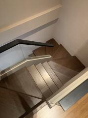 Modern wooden staircase with glass railing