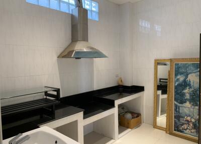 Modern kitchen with stainless steel hood and decorative artwork