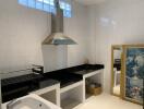 Modern kitchen with stainless steel hood and decorative artwork