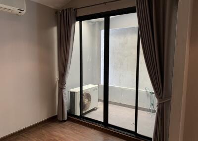 Living room with sliding glass doors leading to a small patio area