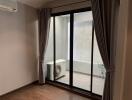 Living room with sliding glass doors leading to a small patio area