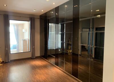 Spacious bedroom with large mirrored wardrobe