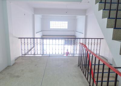 Common area with stairway and railing