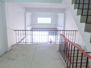 Common area with stairway and railing