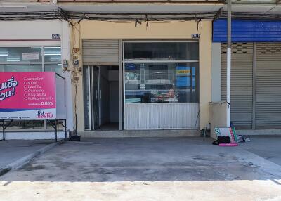 Exterior view of a commercial storefront with glass and metal sliding doors.