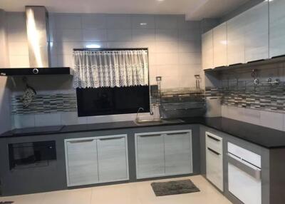 Modern kitchen with stainless steel appliances and white cabinets