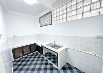 Small kitchen with patterned tile floor and sink