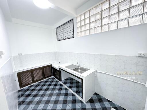 Small kitchen with patterned tile floor and sink