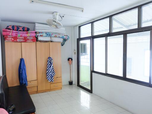 Bedroom with wardrobe and large windows