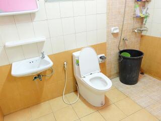 Clean bathroom with tiled walls and a shower area