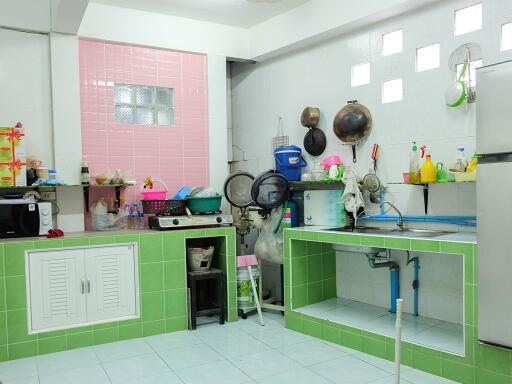 Well-equipped kitchen with colorful tile accents