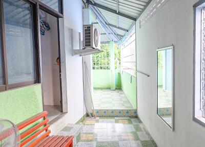 Outdoor hallway with bench and air conditioner