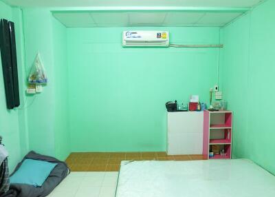 Bedroom with simple furnishings and air conditioner