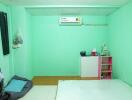 Bedroom with simple furnishings and air conditioner