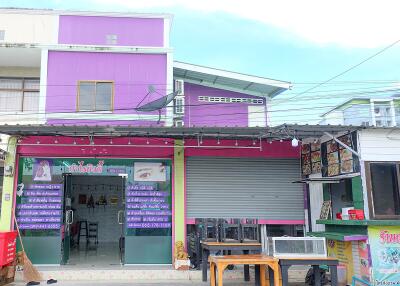 Street view of a commercial property with shops and restaurants