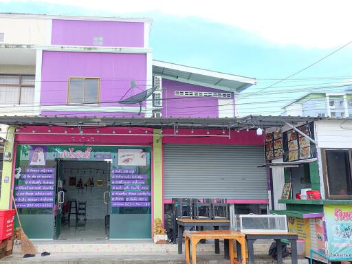 Street view of a commercial property with shops and restaurants