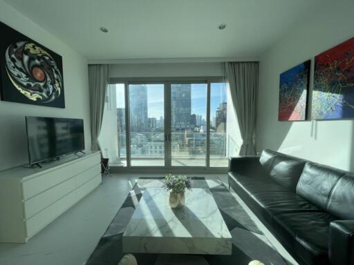 Modern living room with a large window and city view