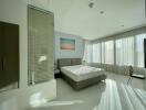 Bright and spacious bedroom with large windows and modern furnishings