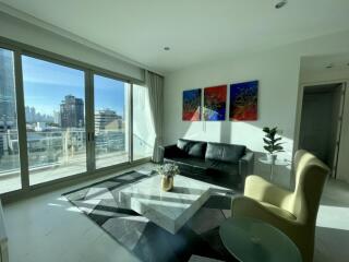 Modern living room with large windows and city view