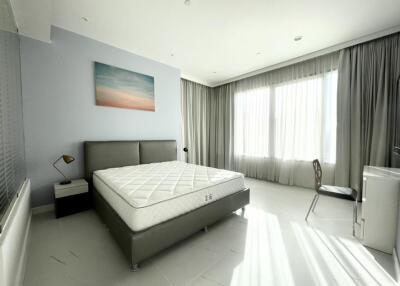 Bright modern bedroom with large window, bed, and desk