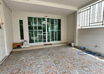 Covered patio area with tiled flooring