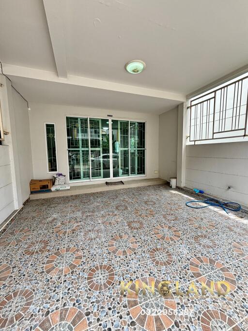 Covered patio area with tiled flooring